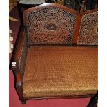 An early 20th century walnut and cane inset three-piece Bergere suite comprising; two-seater sofa