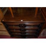 An 18th century oak chest of four long drawers, having brass tear drop handles raised on bun