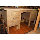 An early 20th century oak and beech rexine inset twin pedestal writing desk, width 152cm