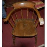 An early 20th century elm seat and beech captain's chair