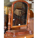 A mid-Victorian mahogany swing toilet mirror raised on serpentine front base