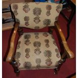 An early 20th century beech upholstered pad back and seat elbow chair, together with an Edwardian
