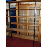 A 1970s oak and black painted metal large freestanding six-tier open display shelf, 210 x 170cm