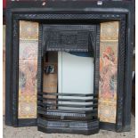 A late Victorian black painted cast iron and tiled inset fire surround, having removable lower cover