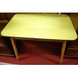 A 1960s yellow formica topped kitchen table, w.105cm