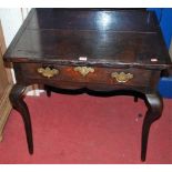 An 18th century provincial oak single drawer side table, having cleated ends and raised on