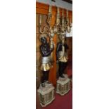 A pair of contemporary decorative figural Blackamoor six branch floor lights, silvered and gilt