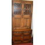 A contemporary Old Charm linenfold oak and lead glazed wall unit, w.91.5cm
