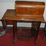 An early 20th century Singer treadle sewing machine table