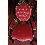 A pair of mid Victorian mahogany framed ladies and gents parlour chairs, each having pink buttoned