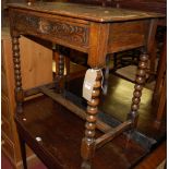 An early 20th century line and relief carved oak single drawer bobbin turned side table, width 76.