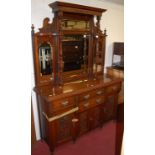 An Edwardian floral relief carved walnut mirrorback sideboard, the four bevelled mirror plates