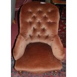 A Victorian walnut framed and green floral buttoned upholstered nursing chair, on cabriole forelegs,