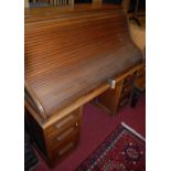 An early 20th century oak roll top desk, width 137cm