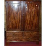 A 19th century mahogany double door press cupboard, having two short over single long lower