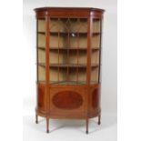 An Edwardian mahogany and inlaid breakfront china display cabinet, the glazed door with satinwood