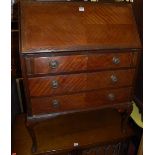 A 1920s mahogany slopefront three drawer writing bureau, having cabriole supports, w.79cm