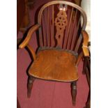 A late 19th century elm wheelback elbow chair, together with a further similar stickback example (