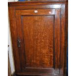 An early 19th century provincial oak single door hanging corner cupboard, h.94cm