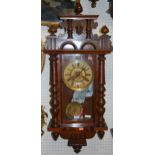 An early 20th century walnut Vienna droptrunk wall clock, with pendulum and key, approx h.90cm