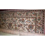 A Persian style machine woven cream ground rugCondition report: Measures 328 x 274cm.
