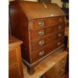 An early 19th century provincial oak slope front writing bureau, having a fitted interior over