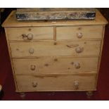 A Victorian pine round cornered chest of two short over three long graduated drawers on turned