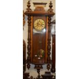 An early 20th century walnut Vienna droptrunk wall clock, with pendulum and key, approx h.125cm