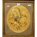 A Victorian silkwork panel, depicting a posy of flowers and framed as an oval (a/f), 31 x 26.5cm
