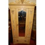An early 20th century floral decorated pine single mirror door wardrobe, having single long lower