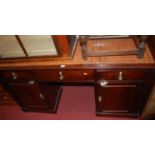 An unusual 19th century mahogany and gilt tooled tan leather inset kneehole writing desk, having
