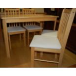 A contemporary rubberwood kitchen table and four chairs (5)