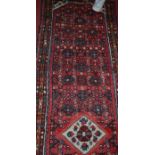 A Persian woollen red ground hall runner, 300 x 80cm