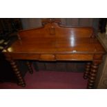 A Victorian oak scroll ledgeback hall table, having opposing end drawers and raised on bobbin turned