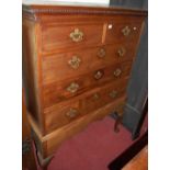 A George III mahogany chest on stand, the dental mounded cornice over two short and three long