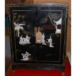 A contemporary Japanese black lacquered and mother of pearl inset double door low side cupboard,