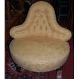 A Victorian mahogany framed and yellow floral buttoned upholstered shaped back nursing chair, raised