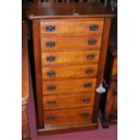 A Victorian oak round cornered seven drawer Wellington chest, having twin locking panels, with