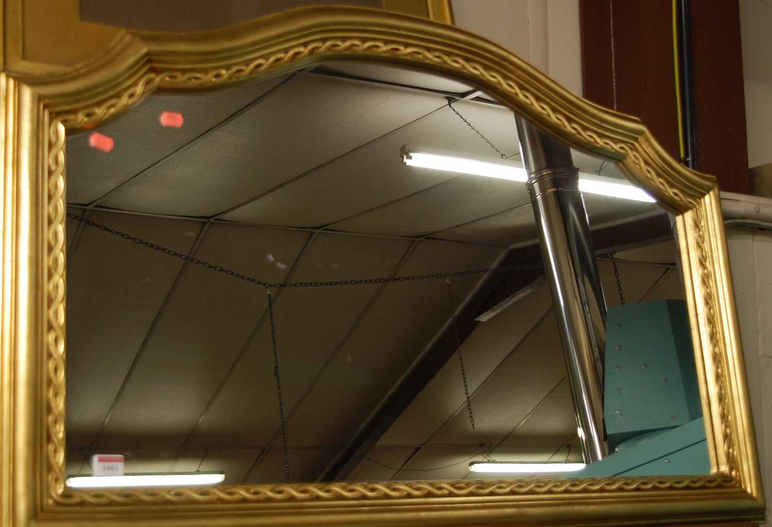 A modern gilt composition framed wall mirror, w.105cm