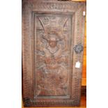 An antique blind carved oak panel, formally being a cupboard door, with iron escutcheon, 70 x 39cm