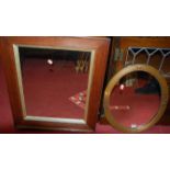 A gilt framed oval wall mirror, 52 x 41cm; together with an oak framed example (2)
