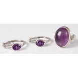 A contemporary white metal and cabochon amethyst set dress ring, stamped 925, size N, together