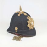 A blue cloth covered helmet, having a brass spike above a brass helmet plate for the Royal Anglians,