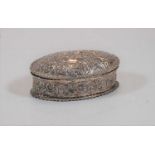 A circa 1900 silver and embossed trinket box of oval form, 2.1oz, 10cm