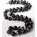 A knotted banded agate beaded necklace with white metal clasp, 141g, 70cm