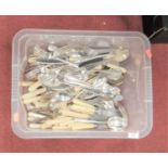 A box of assorted loose flatware together with a cased set of cake forks with teaspoons