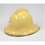 A yellow painted fireman's helmet, size medium, numbered 57-59, having leather liner and chin strap