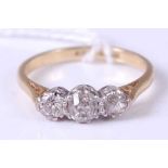 An 18ct gold diamond three stone ring, the centre round cut diamond weighing approx 0.25ct, 3.4g,