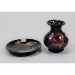 A Moorcroft Pottery vase in the Hibiscus pattern; together with a similar dish, dia.12cm (2) (Note