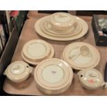 An Art Deco Wedgwood part dinner service, on a cream ground with orange transfer decoration,